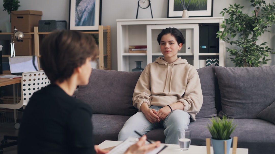 Two adults having a supportive conversation in a comfortable community setting