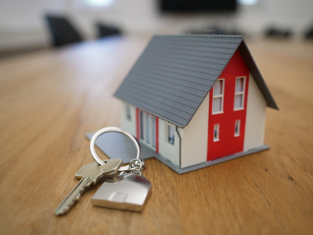 House keys and model home representing a property partnership
